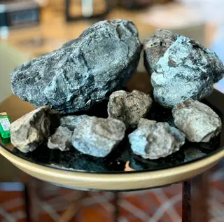 Two big blue-grey ambergris pieces resting above smaller ones