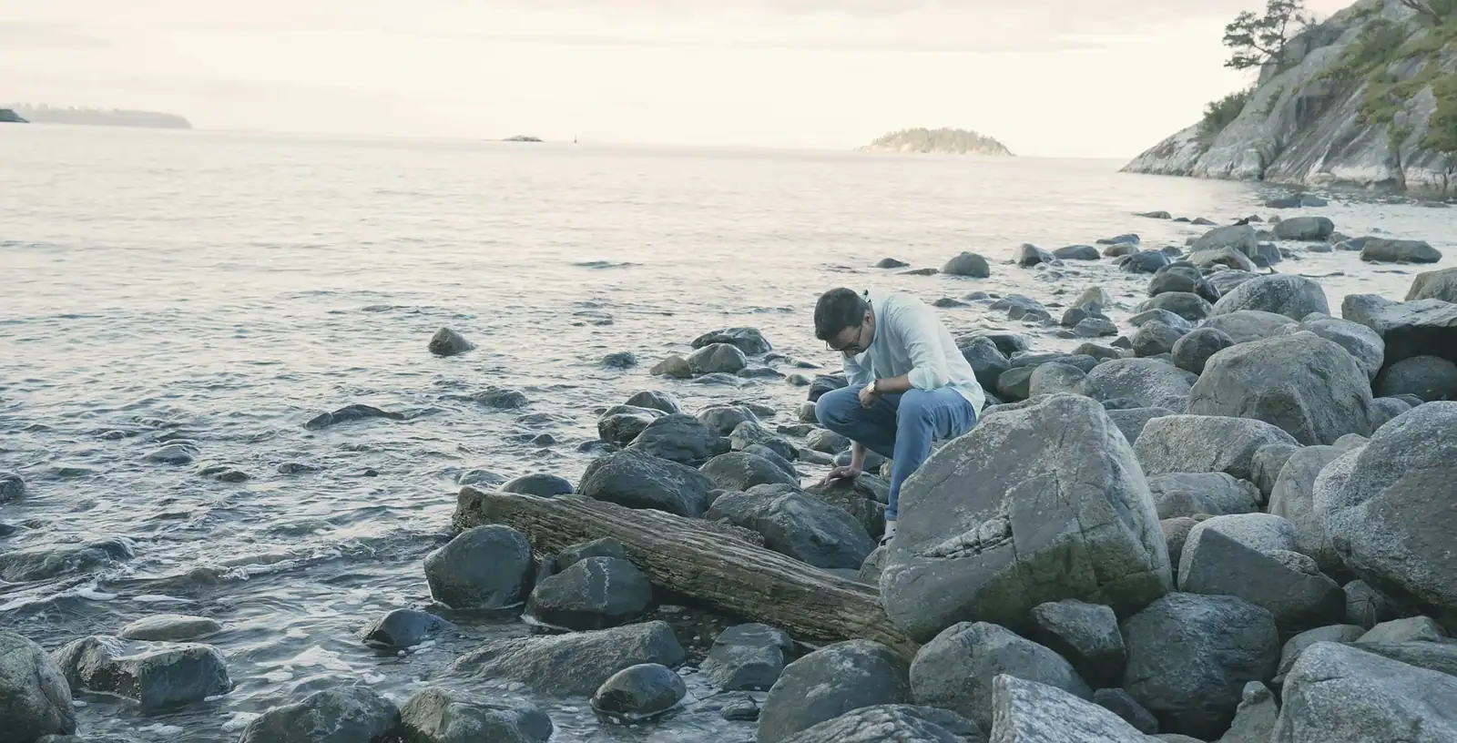 Nabil Valiulla searching among shore boulders at low tide